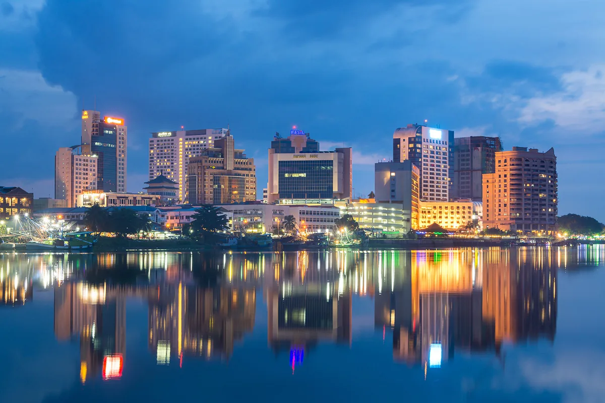 The Kuching skyline at dusk, seen across the river.